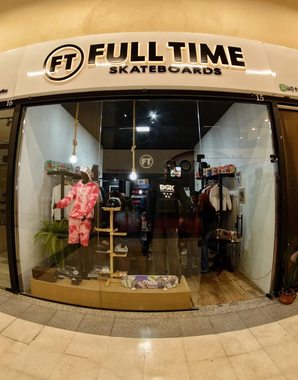A fachada da Full Time Skateboards na Galeria Xaxim, loja 15, com a vitrine acesa